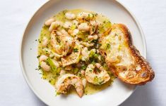 a white plate topped with shrimp and bread