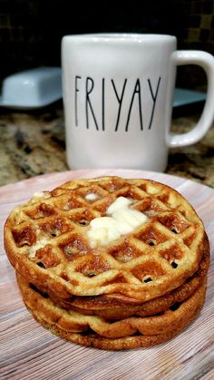 three waffles stacked on top of each other next to a coffee mug that says friyay