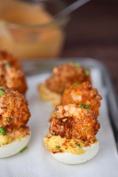 deviled eggs stuffed with meat and garnished with parsley on a tray