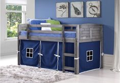 a bunk bed with blue sheets and curtains on the bottom is next to a white rug