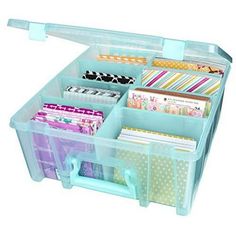 a plastic storage box filled with lots of different types of papers and stationery items