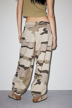 Forever cool Out From Under sweatpant in an oversized, jogger style. Designed in an all-over camo printed knit featuring a low-rise elasticized waistband, drawstring tie and wide balloon legs with cinched hems. Only at Urban Outfitters. Features Out From Under Brenda jogger sweatpant Balloon lounge sweatpant All-over camo print knit Low rise elasticized waistband with drawstring tie Wide balloon legs Cinched elastic hems Oversized, relaxed fit Full length Easy pull-on style UO exclusive Content Sporty Camouflage Bottoms With Pockets, Sporty Camouflage Cotton Bottoms, Camouflage Sweatpants With Pockets For Streetwear, Baggy Khaki Joggers For Streetwear, Fall Khaki Sweatpants For Streetwear, Fall Streetwear Khaki Sweatpants, Camouflage Relaxed Fit Bottoms With Elastic Waistband, Khaki Joggers With Elastic Waistband For Streetwear, Camouflage Bottoms With Elastic Waistband For Fall