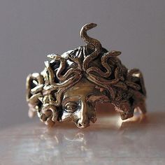 an intricately designed ring sits on a table