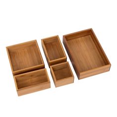 four square wooden boxes with compartments on each side and one empty box in the middle