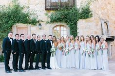 a group of people standing next to each other in front of a building