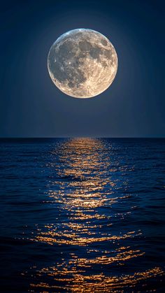 the full moon shines brightly in the night sky over the ocean as it reflects on the water