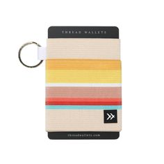 a multicolored wallet with a keychain hanging from it's side