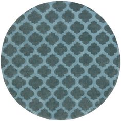 a circular rug with an intricate pattern on the top in teal green and black