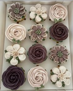 cupcakes decorated with flowers in a box