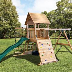 a wooden swing set with a green slide