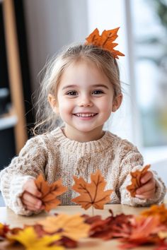 Smiling girl holding autumn leaves indoors. Autumn Kids Crafts, Leaf Collage, Simple Leaf