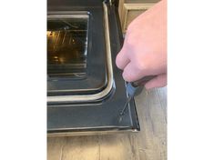 a person is pulling something out of an oven