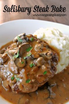 a white plate topped with meat covered in mushroom gravy and mashed potatoes