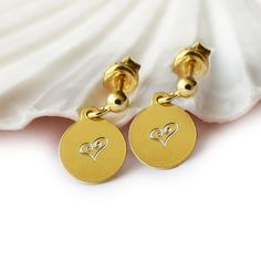 Gold Plated Disc Earrings A stylish pair of gold palted earrings, with small round discs with heart design. On the back the discs can be engraved with your wished initials (max. 3 characters). They will make a perfect gift for someone special who loves unique jewelry. Sent in a gift box. Disc (in diameter): approx. 0.9 cm  Material: gold plated  925 Sterling Silver Type of engraving: diamond engraving More personalized ear jewelry: https://www.etsy.com/shop/latigga?section_id=25944573 LATIGGA SH Engraved Initials, Disc Earrings, Ear Jewelry, Round Earrings, Heart Design, Heart Earrings, Gifts For Women, Jewelry Earrings Dangle, Initials