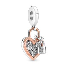 This Heart Padlock Double Dangle Charm is decorated with a tiny padlock, inspired by the locks that lovers place on bridges around the world to represent their everlasting love. The meaningful charm features the silhouette of a heart in 14K rose gold plating that outlines a sterling silver heart pavé-set with brilliant-cut cubic zirconia. The sterling silver padlock is finished with the engraving "Together always" and holds the two elements next to each other, symbolizing two hearts coming toget Charms Disney, New Pandora Charms, Pandora Rose, Pandora Heart, Charms Pandora, Heart Padlocks, Pandora Beads, Bracelet Pandora, Pandora Hearts