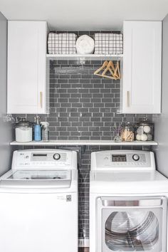 a white washer and dryer sitting next to each other in a laundry room