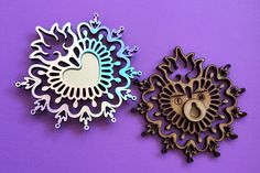 two decorative wall hangings on a purple background, one with a circular mirror and the other with an animal's head