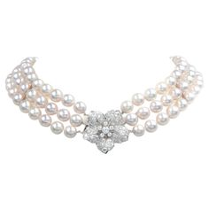 In addition to your diamond & pearl collection, this necklace is the upgrade to bring your style to the next level.  A triple strand of genuine Akoya High lustrous Japanese pearls, pink undertones with high luster & polish, measuring 9 mm. The center of this exquisite piece is set with Old European cut Diamond in the center and with dazzling sparkle weighing approximately 6.50 carats in total ( G-H color and VS clarity) Secured with a Platinum, diamond accented, hibiscus flower motif  Insert Clasp. The clasp/Pendant  measures approximately 33 mm x 33 mm, And the total length is 15", and the shortest strand is 13" Remains in Excellent Condition. Purity Marked. Accompanied by an official appraisal document. Luxury Akoya Pearl Necklaces, Luxury Double Strand Pearl Jewelry, Japanese Pearls, Vintage Choker Necklace, Vintage Choker, Pearl Jewellery, Luxury Jewellery, Pearl Collection, Flower Motif