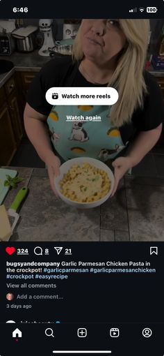 a woman holding a bowl of food in her hands and looking at the camera screen