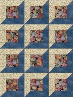 a blue and white quilt with flowers on it