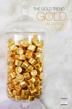 a glass jar filled with gold wrapped candy