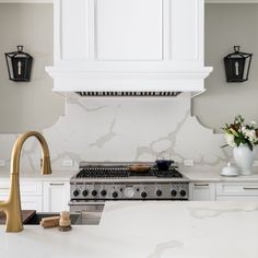 a kitchen with white cabinets and an oven