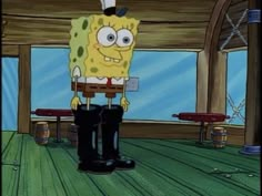 spongebob standing in front of a window with his feet on the ground and wearing black boots