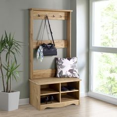 a wooden bench sitting next to a window with a handbag on top of it