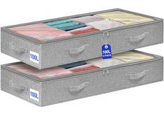 two gray storage boxes with labels on them and some folded fabric in the bottom drawer