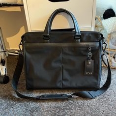 Nylon With Leather Details Lightweight Unisex Used Only 2 Times. In Almost New Condition Black Lots Of Pockets Throughout Tumi Bags, Lots Of Pockets, New Color, Like New, Man Shop, Leather, Black, Color