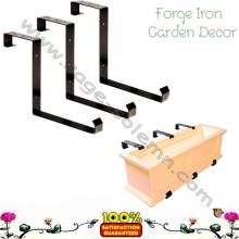 three black iron garden decor brackets on white background with pink flowers in the foreground