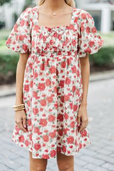 This babydoll dress is so precious and we love print! This floral dress is going to look fabulous for any nice event! This dress will style beautifully with your favorite heels or booties! Square neckline Short bubble sleeves Babydoll cut Pockets Floral print No stretch Baileigh is wearing the small. Red Floral Print Puff Sleeve Dress, Cute Red A-line Dress, Red Puff Sleeve Dress For Garden Party, Red Flowy Dress With Smocked Bodice, Red Floral Print Knee-length Dress, Red Floral Dress For Garden Party, Red Knee-length Dress With Floral Print, Red Smocked Bodice Mini Dress For Summer, Red Mini Dress With Smocked Bodice For Summer