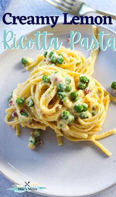 creamy lemon ricotta pasta with peas on a white plate