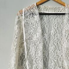 Original vintage lace jacket in perfect condition. Ideal for layering or a Beach cover up. Loose style fitting with no fastening. Chest measures 38 inches between arm to arm flat. Length 24 inches Long Sleeve White Lace Top For Wedding, Long Sleeve Lace Top For Wedding, White Long Sleeve Lace Top For Wedding, Vintage Lace Top With Long Sleeves For Wedding, Delicate Lace Long Sleeve Top For Wedding, Vintage Long Sleeve Lace Top For Wedding, White Lace Top For Wedding Night, Fitted Lace Outerwear For Wedding, Spring Wedding Lace Outerwear