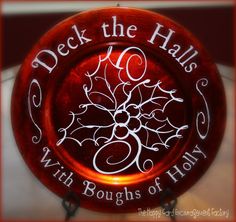 a red plate that says deck the hall with boughs of holly