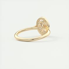 a yellow gold ring with an interlocked design on the front and center side