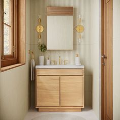 a bathroom with a sink, mirror and wooden cabinetry in it's corner