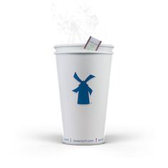 a white cup with a blue windmill on it