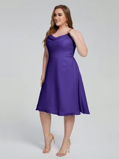 a woman in a purple dress posing for the camera with her hands on her hips