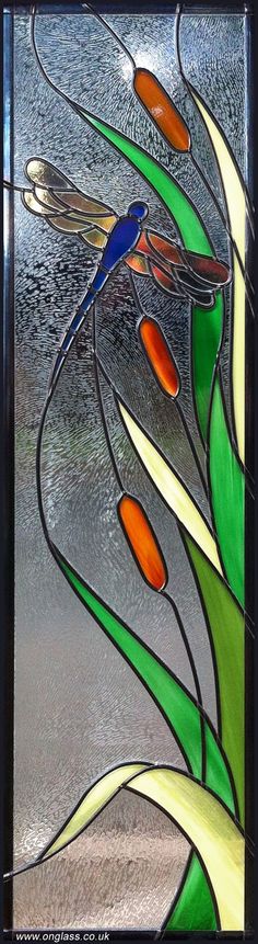 a stained glass window with orange and green flowers