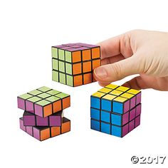 a hand is trying to solve three cubes in the same color as they appear