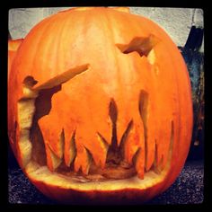 an orange pumpkin carved to look like it has teeth