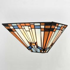 a stained glass light fixture hanging from the ceiling