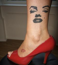 a woman's foot with her face painted on it