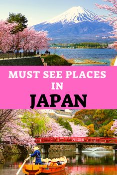 a boat floating on top of a body of water next to mountains and trees with pink flowers