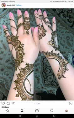 two hands with henna tattoos on them