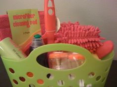 a green basket filled with lots of cleaning supplies