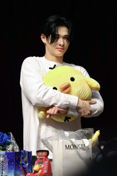 a man holding a stuffed animal in his arms