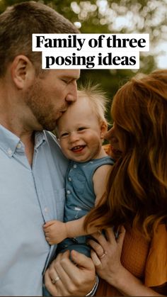 a man and woman holding a baby in their arms