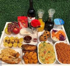 a table topped with lots of food and condiments next to bottles of wine